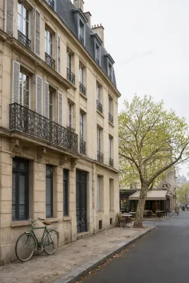 A green bicycle parked on a sidewalk in front of a historic stone building with iron balconies and wooden shutters.