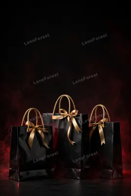 Three glossy black shopping bags with gold rope handles and gold ribbon bows on a black backdrop with subtle deep-red glow and large empty copy space above