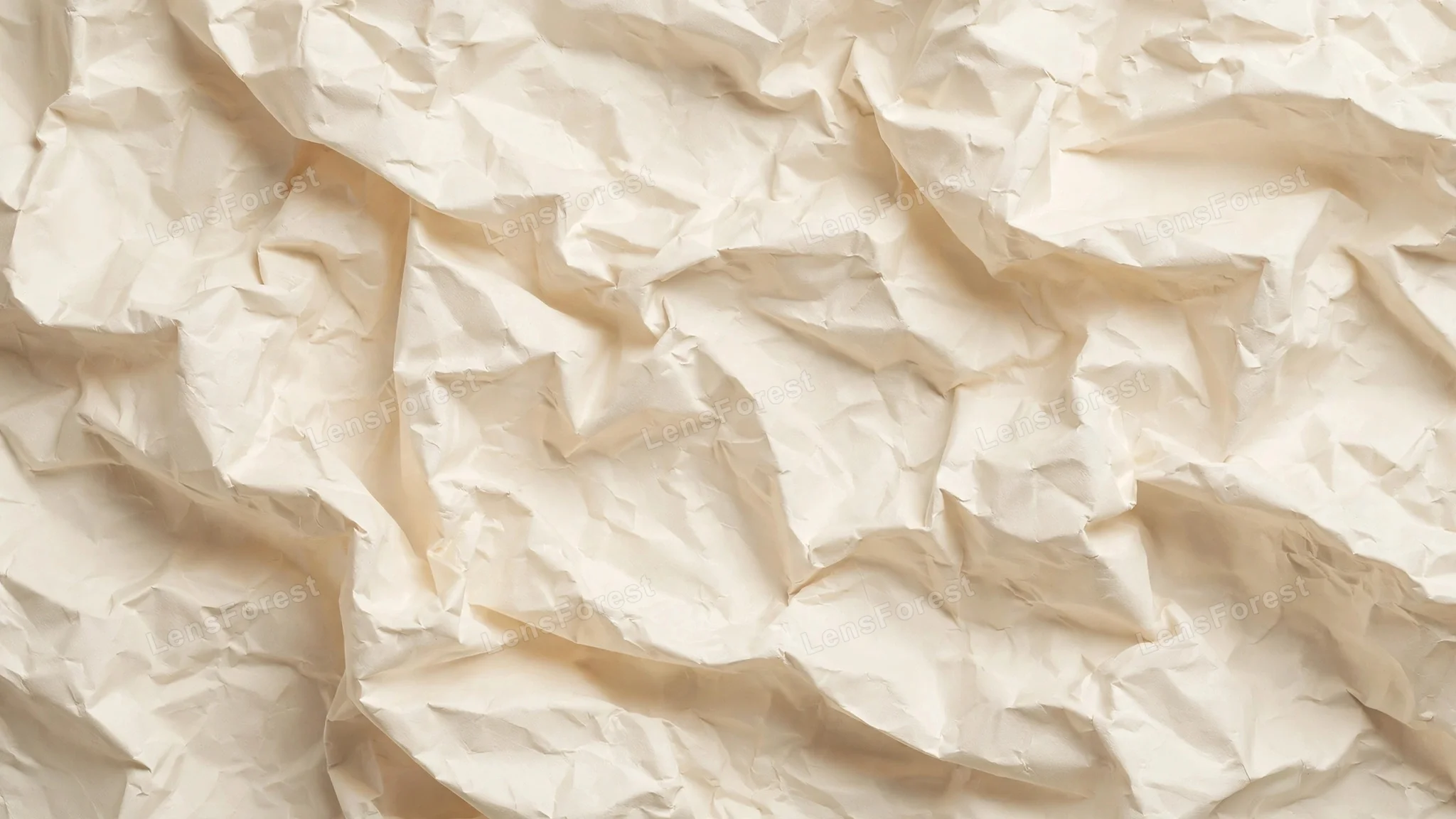 Full-frame crumpled cream paper texture with soft shadows in the folds, a warm vintage background for designs