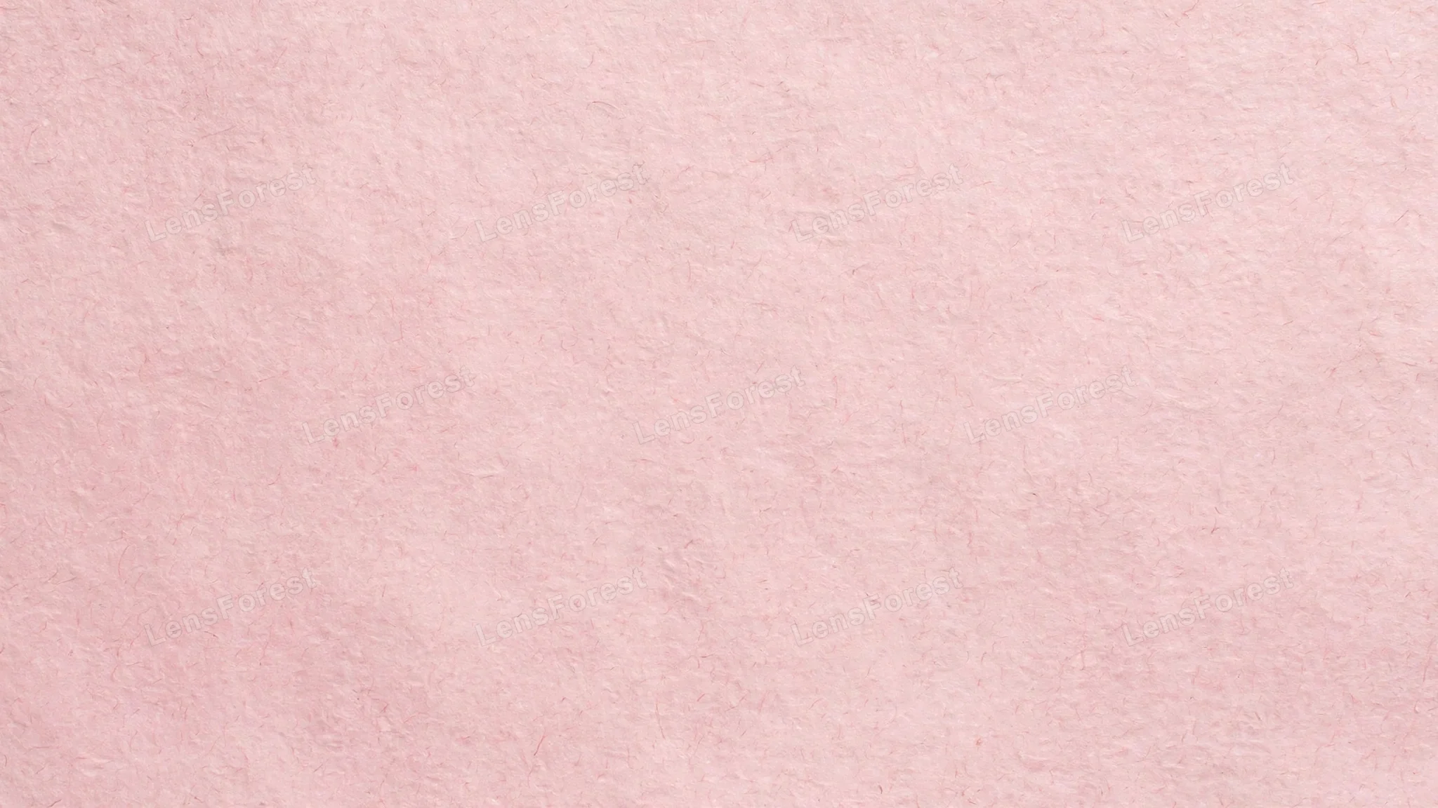 A full-frame pastel pink paper texture with a soft matte finish and gentle fiber detail
